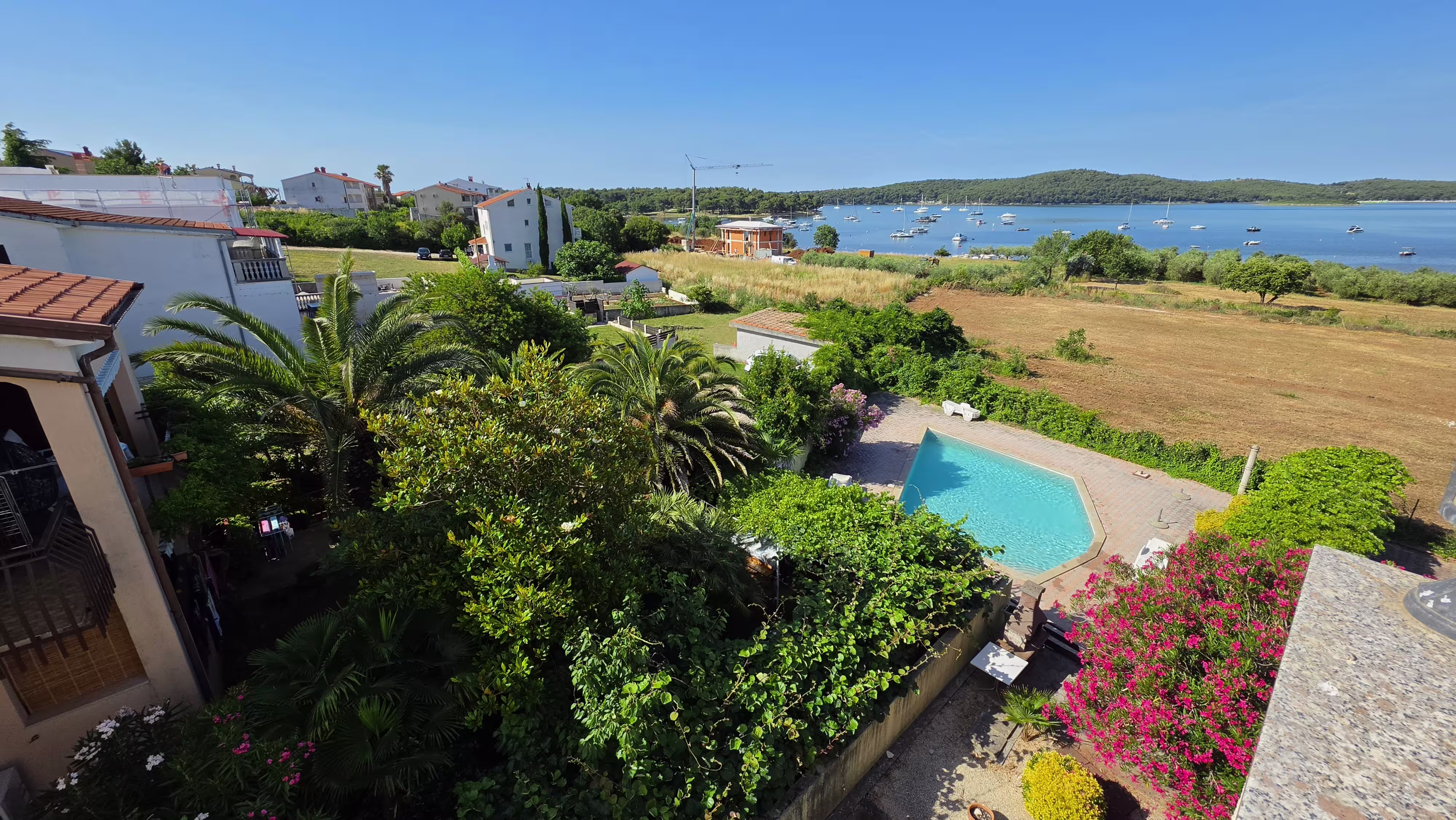 Swimming pool and terrace at Villa Viva pension in Medulin at sunset